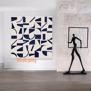 May include: A minimalist abstract painting with geometric shapes in black and white on a cream background. The painting is hanging on a white wall in a modern interior. The text "Minimalist painting" is written below the painting.