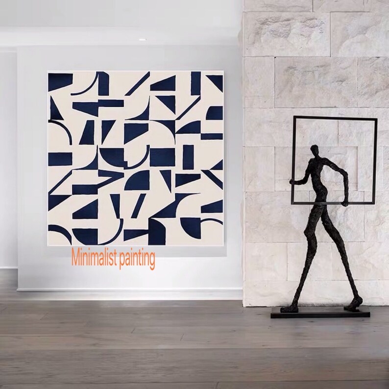 May include: A minimalist abstract painting with geometric shapes in black and white on a cream background. The painting is hanging on a white wall in a modern interior. The text "Minimalist painting" is written below the painting.