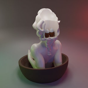 May include: A white ceramic sculpture of a person with their head open, revealing two eggs inside. The sculpture is sitting in a brown bowl.