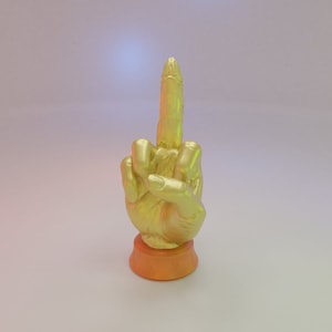 May include: A gold-colored hand sculpture making the middle finger gesture. The hand is on a small orange base.