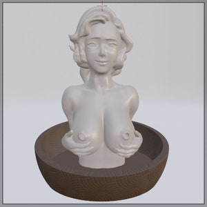 May include: A white ceramic figurine of a woman with her hands clasped around her breasts. The figurine is sitting in a brown, circular dish with a decorative pattern.
