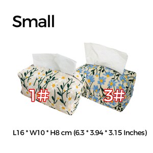 May include: Two small tissue box covers with floral embroidery. One cover features white daisies on a beige background, the other has blue flowers on a beige background. Both covers are 6.3 inches long, 3.94 inches wide, and 3.15 inches high.