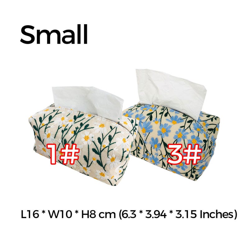 May include: Two small tissue box covers with floral embroidery. One cover features white daisies on a beige background, the other has blue flowers on a beige background. Both covers are 6.3 inches long, 3.94 inches wide, and 3.15 inches high.