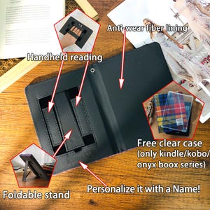 May include: Black e-reader case with a foldable stand and anti-wear fiber lining. Features include handheld reading support and a free clear case for select models. The case can be personalized.