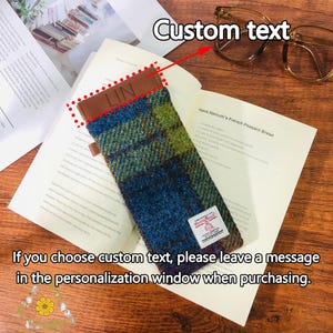 May include: A blue and green plaid glasses case with a brown leather flap. The flap has the word "LIN" embossed on it. The case is lying on a book with the text "Hans Namuth's French Peasant Bread". The text "Custom text" is written above the case with an arrow pointing to it. The text "If you choose custom text, please leave a message in the personalisation window when purchasing." is written below the case.