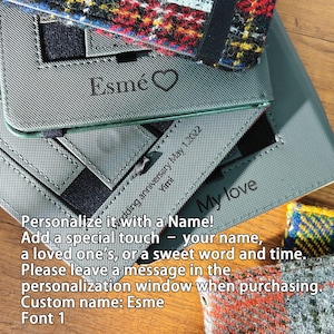 May include: Gray personalized notebook covers with the name "Esm&eacute;" and a heart symbol. The text "My love" and "Wedding anniversary May 1, 2022" are also visible. The covers are shown with a colorful plaid fabric.