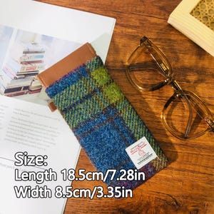 May include: A blue, green, and brown plaid glasses case with a brown leather top. The case is 7.28 inches long and 3.35 inches wide. The text on the case reads "Size: Length 18.5cm/7.28in Width 8.5cm/3.35in".