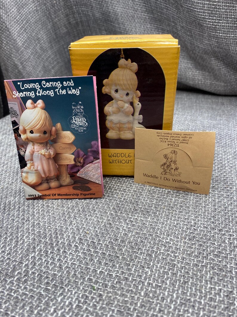May include: A porcelain figurine of a young girl holding a goose. The figurine is part of the Precious Moments collection and is titled "Waddle I Do Without You". The figurine is a 1993 Symbol of Membership Figurine.