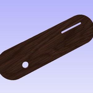 Może przedstawiać: Drewniany uchwyt w ciemnobrązowym kolorze z okrągłym otworem i długim wycięciem. Uchwyt jest gładki i ma słoje drewna.