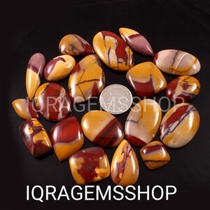 May include: A collection of polished, oval-shaped stones in shades of yellow, red, and cream. The stones vary in size and shape, with a coin included for scale. The text "IQ RAGEMSSSHOP" is visible at the bottom of the image.