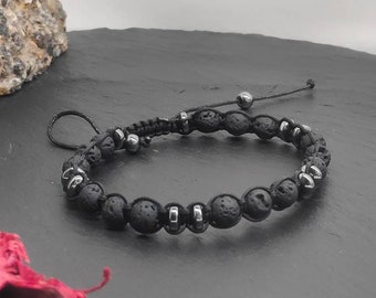 May include: Black lava rock beaded bracelet with silver metal accents and a black cord.