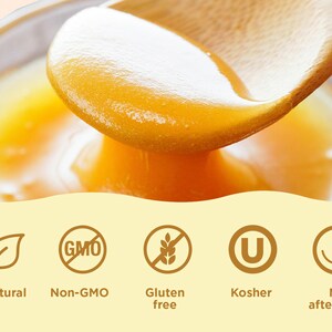 May include: A close-up of a wooden spoon scooping golden honey from a glass bowl. The honey is thick and viscous, and the spoon is dripping with honey. The image includes text that reads "All natural", "Non-GMO", "Gluten free", "Kosher", and "No aftertaste".
