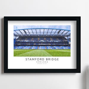 May include: A framed print of Stamford Bridge, the home of Chelsea Football Club. The image shows the stadium's exterior with a blue and white color scheme. The text "Stamford Bridge, Chelsea, Opened in 1877" is printed below the image.