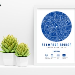 May include: A white framed print with a blue map of Stamford Bridge, Chelsea, London. The print includes the coordinates 51&deg;28'54.3"N 0&deg;11'27.4"W and the text "Stamford Bridge, Chelsea".