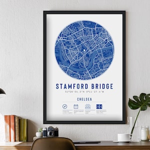 May include: A blue and white map print of Stamford Bridge, a football stadium in Chelsea, London, England. The print includes the stadium's coordinates and the text "Stamford Bridge" and "Chelsea".