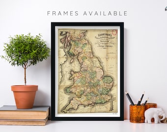 May include: A framed vintage map of Great Britain, titled "Bradshaw's Railway and Steam Navigation Stations 1845". The map is printed in black, brown, green, and yellow on a cream-colored background. The map is framed in a black frame.