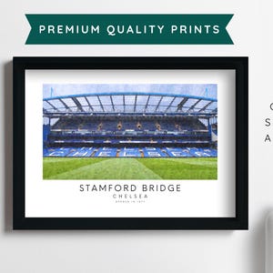 May include: A watercolor painting of Stamford Bridge, the home of Chelsea Football Club. The stadium is shown in a blue and green color scheme with the text "Stamford Bridge Chelsea Founded in 1905" below the image.