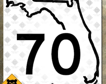 May include: A white metal sign featuring a black outline of the state of Florida with the number 70 in large, bold font. The sign includes two small holes for hanging and a bear warning sign in the lower left corner.