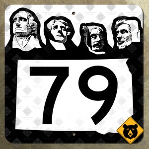 May include: Black and white sign with the number 79 in a white circle. The sign has a black background with a white border. The top of the sign features a black and white image of four faces. The bottom of the sign has a yellow diamond with a black bear inside.