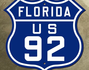 May include: Blue and white US highway sign with the text "FLORIDA US 92" on it.