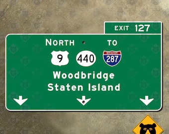 May include: Green highway sign with white text and arrows. The sign reads "Exit 127", "North", "9", "440", "Interstate 287", "Woodbridge", and "Staten Island".