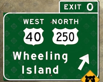 May include: Green highway sign with white text and numbers. The sign reads "Exit 0", "West 40", "North 250", "Wheeling Island". A white arrow points to the right. A yellow diamond-shaped sign with a black bear silhouette is in the lower right corner.