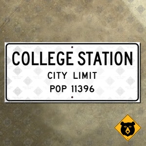 May include: White rectangular sign with black text that reads "COLLEGE STATION CITY LIMIT POP 11396".