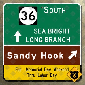 May include: A green and brown sign with white text and a black circle with the number 36 inside. The sign reads "South Sea Bright Long Branch Sandy Hook Fee: Memorial Day Weekend Thru Labor Day".