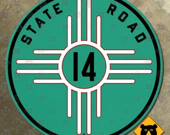 May include: A round, teal State Road 14 sign with white and red accents. The sign features the text "STATE ROAD" in black, encircling a central design with the number "14". A small yellow bear crossing sign is in the lower right corner.