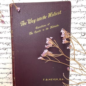May include: A burgundy hardcover book titled "The Way into the Holiest" with gold lettering. The book is a collection of expositions of the Epistle to the Hebrews by F.B. Meyer, B.A.