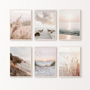 May include: Set of six framed art prints featuring serene coastal and natural landscapes. The images showcase beach scenes, a wooden pier, and fields of tall grass, all in soft, neutral tones with a focus on natural light and calming aesthetics.