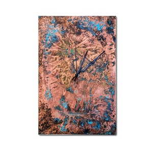 May include: A square copper clock with a blue and green patina. The clock face has black hands and a black center.