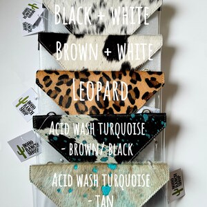 May include: Six triangular cowhide pouches arranged vertically. Patterns include tan and white, black and white, brown and white, leopard print, acid wash turquoise with brown and black, and acid wash turquoise with tan. Each has a metal snap closure.
