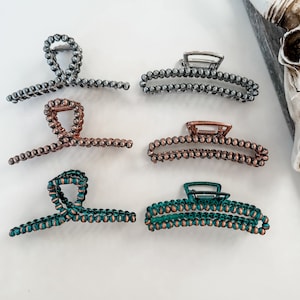 May include: Set of six hair clips with a beaded design. The clips are in silver, copper, and teal colors.