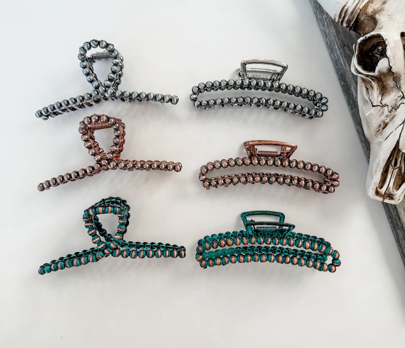 May include: Set of six hair clips with a beaded design. The clips are in silver, copper, and teal colors.