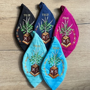 May include: Five fabric pouches with drawstring closures, each featuring a different color and embroidered with a Tulsi plant, the words "Tulsi" and "Brinda Maharani".