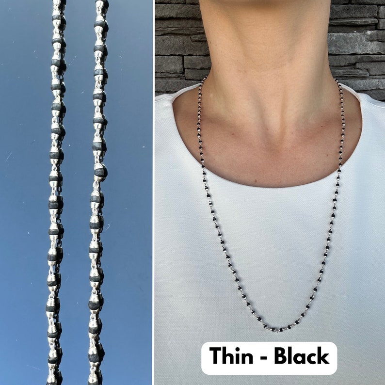 Puede incluir: Un collar de cadena de plata con cuentas negras. El collar es delgado y tiene un dise&ntilde;o simple. El texto "Thin - Black" es visible en la parte inferior de la imagen.