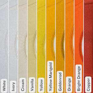 May include: A color palette featuring nine fabric swatches in shades of white, ivory, cream, vanilla, yellow, yellow marigold, goldenrod, orange, bright orange, and copper. Each swatch has a rounded neckline.