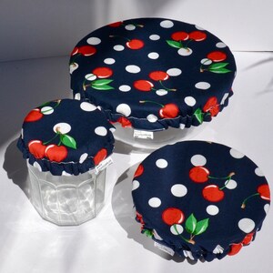 Può includere: Tre coperchi per alimenti riutilizzabili in tessuto blu navy con pois bianchi e stampa a ciliegie. I coperchi sono in cotone e sono progettati per adattarsi a ciotole e barattoli per mantenere il cibo fresco.