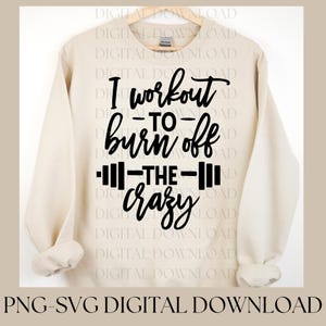 May include: A beige sweatshirt with black text that reads "I workout to burn off the crazy". The text is stylized with a barbell graphic.
