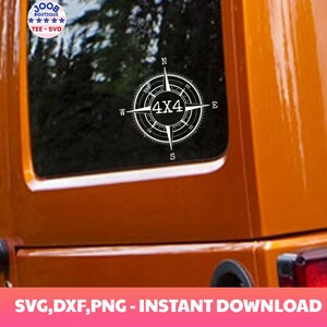 May include: A white compass with a black 4x4 design on a orange Jeep. The compass has the letters N, S, E, and W around the compass.