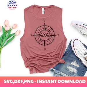 May include: A pink sleeveless tank top with a black compass design featuring the text "4x4" in the center. The compass points are labeled N, S, E, and W.