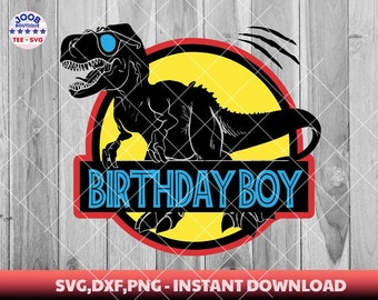 May include: A black silhouette of a dinosaur wearing sunglasses in a yellow circle with a red border. The text "BIRTHDAY BOY" is in a blue banner below the circle. The background is a wood grain pattern.
