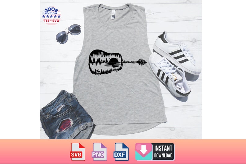 May include: A gray tank top with a black guitar graphic featuring a forest and lake scene. The image also includes white sneakers with black stripes, sunglasses, and denim shorts. The top has a scoop neck.