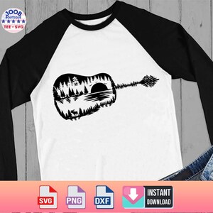 May include: White and black raglan long-sleeve shirt featuring a black guitar silhouette with a nature scene design. The guitar design includes trees, a lake, a sunset, and a deer. The shirt has the text "100B Boutique Tee SVG".