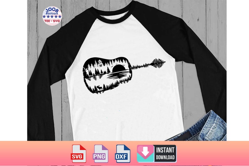 May include: White and black raglan long-sleeve shirt featuring a black guitar silhouette with a nature scene design. The guitar design includes trees, a lake, a sunset, and a deer. The shirt has the text "100B Boutique Tee SVG".