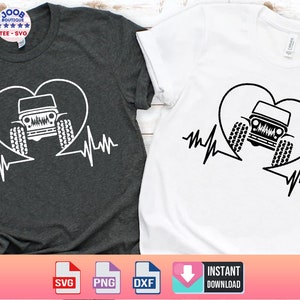 May include: Two t-shirts with a black and white graphic of a jeep inside a heart with a heartbeat line. The t-shirts are one grey and one white.