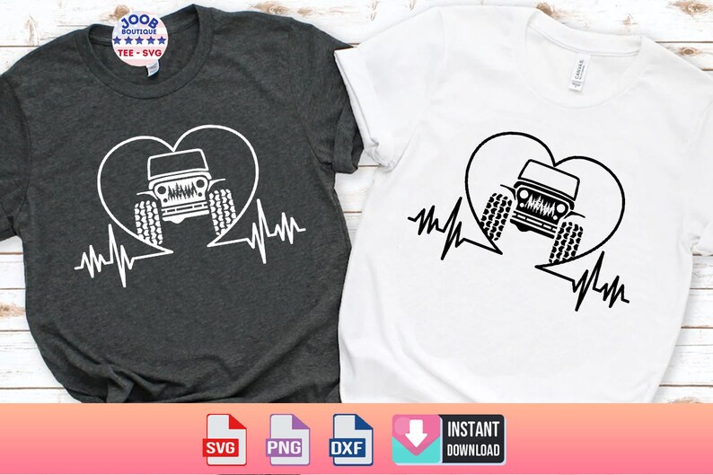 May include: Two t-shirts with a black and white graphic of a jeep inside a heart with a heartbeat line. The t-shirts are one grey and one white.
