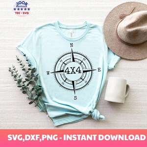 May include: A light blue t-shirt with a black and white compass design featuring the text "4x4" in the center. The compass is surrounded by the cardinal directions: N, S, E, W.