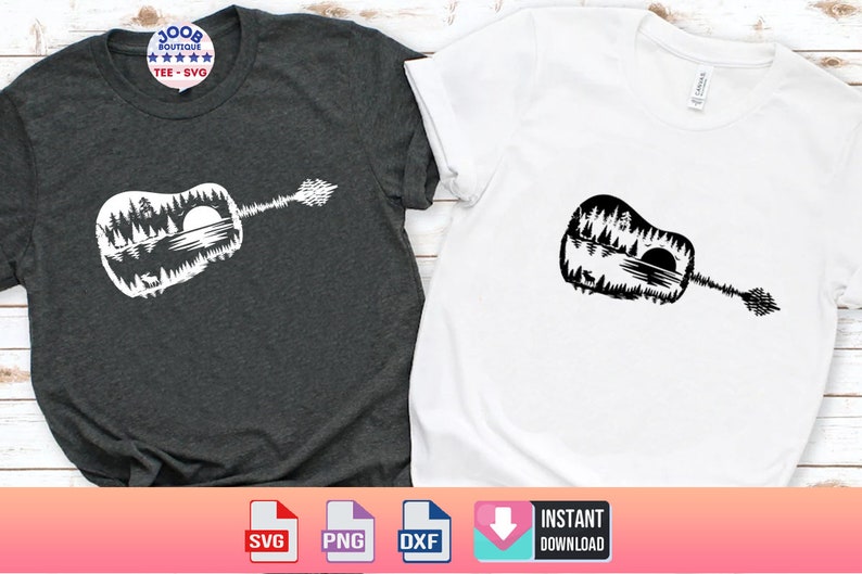 May include: Two t-shirts, one dark gray and one white, each featuring a guitar-shaped design. The design is a silhouette of a forest scene with trees, a lake, and a sun. The dark gray shirt has a circular logo that says "100B BOUTIQUE TEE - SVG".